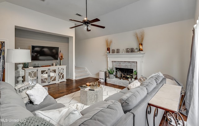 708 Oak Trl, Canton, MS 39046 - living room with wood finished floors, ceiling fan, vaulted ceiling, a brick fireplace, and baseboards