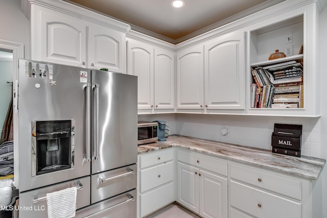 708 Oak Trl, Canton, MS 39046 - kitchen featuring appliances with stainless steel finishes, white cabinets, light stone countertops, and recessed lighting