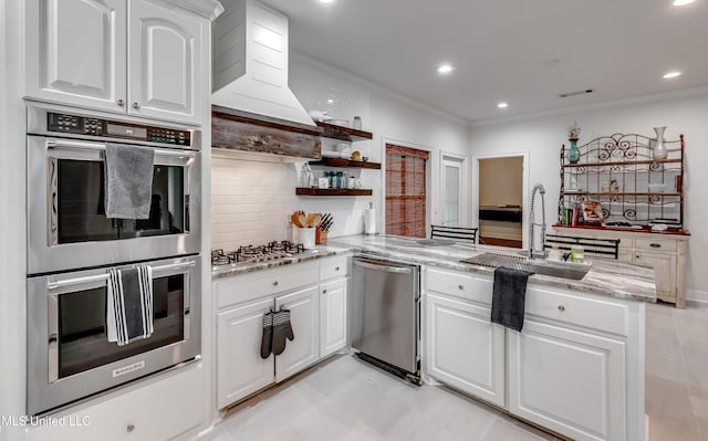 708 Oak Trl, Canton, MS 39046 - kitchen featuring stainless steel appliances, a sink, open shelves, ornamental molding, and a peninsula