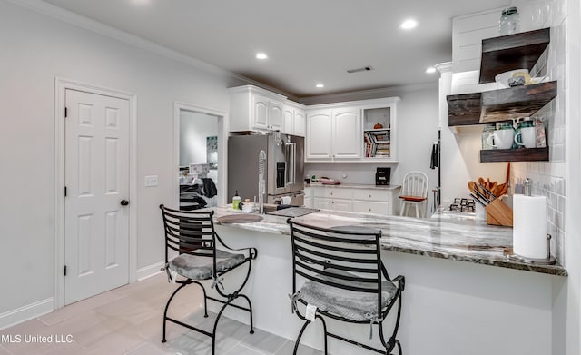 708 Oak Trl, Canton, MS 39046 - kitchen featuring high end fridge, open shelves, a peninsula, white cabinetry, and crown molding