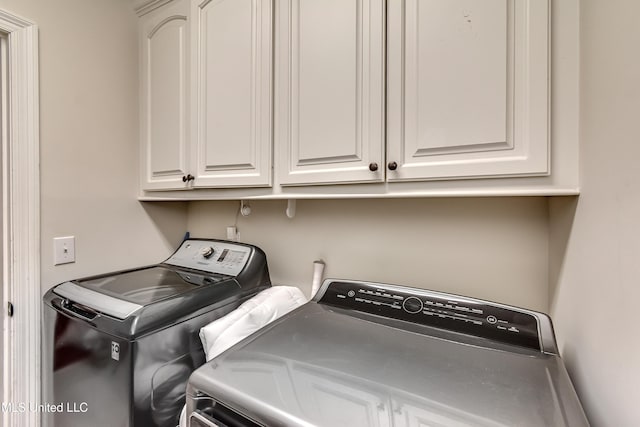 708 Oak Trl, Canton, MS 39046 - laundry area with washer and clothes dryer and cabinet space