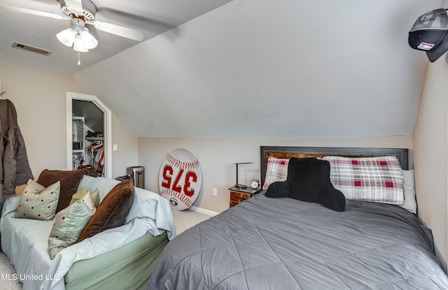 708 Oak Trl, Canton, MS 39046 - carpeted bedroom with vaulted ceiling, a spacious closet, a closet, a ceiling fan, and baseboards