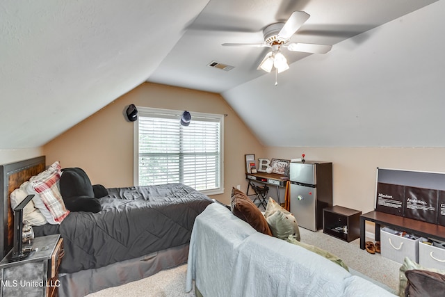 708 Oak Trl, Canton, MS 39046 - bedroom with freestanding refrigerator, carpet, a ceiling fan, and lofted ceiling