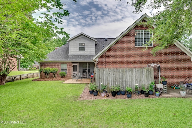 708 Oak Trl, Canton, MS 39046 - back of property featuring a sunroom, a patio, brick siding, and roof with shingles