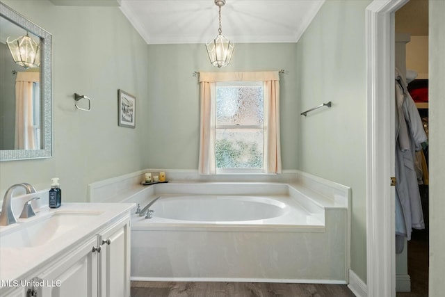bathroom with wood finished floors, a garden tub, vanity, and crown molding