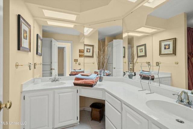 bathroom featuring double vanity, tile patterned flooring, and a sink