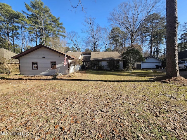 back of property featuring a lawn