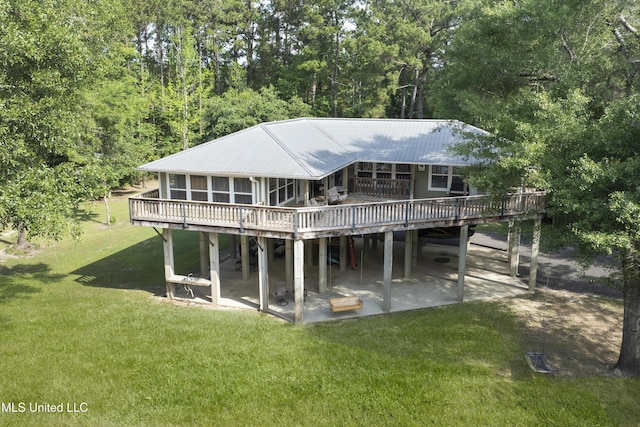5297 Tuxachanie Dr, Biloxi, MS 39532 - back of property with a deck, a patio, a lawn, and metal roof
