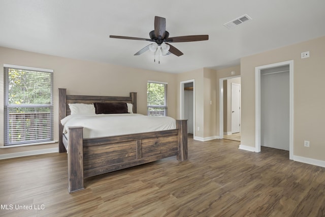 5297 Tuxachanie Dr, Biloxi, MS 39532 - bedroom featuring wood finished floors, baseboards, two closets, and a ceiling fan