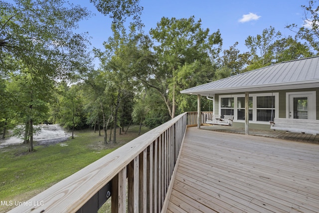 5297 Tuxachanie Dr, Biloxi, MS 39532 - wooden terrace featuring a lawn and view of wooded area
