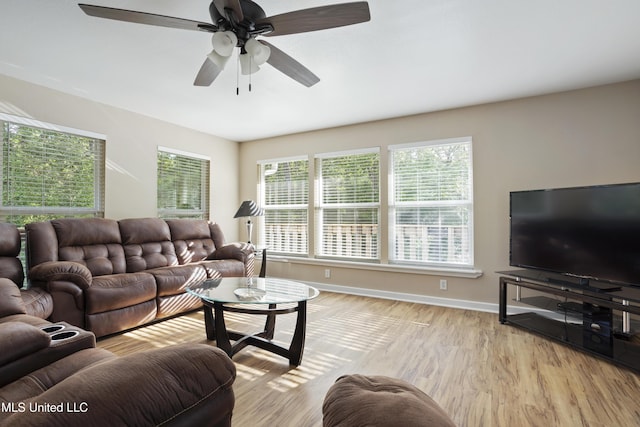 5297 Tuxachanie Dr, Biloxi, MS 39532 - living room with healthy amount of natural light, a ceiling fan, light wood-style floors, and baseboards