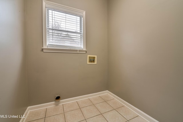 laundry area featuring laundry area, tile patterned flooring, hookup for a washing machine, and baseboards