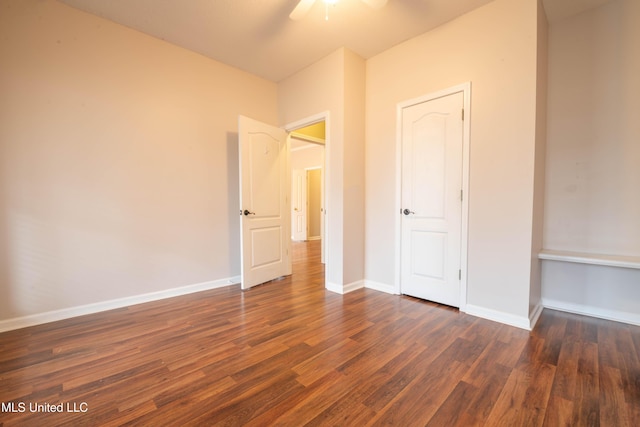 unfurnished bedroom featuring a ceiling fan, dark wood-style flooring, and baseboards