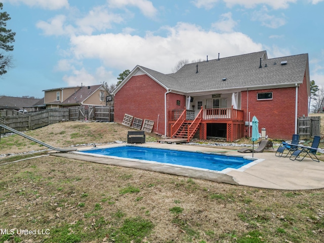 view of pool with a patio area, a fenced backyard, a deck, and a yard