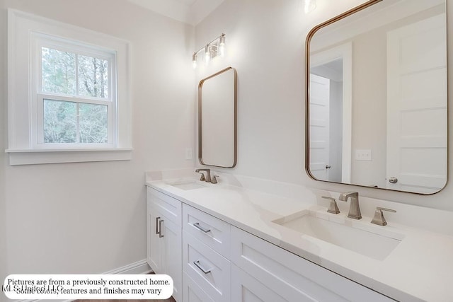 full bathroom with double vanity and a sink
