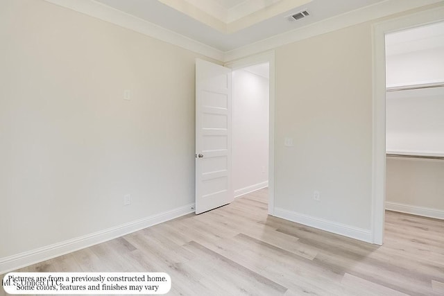 unfurnished room featuring visible vents, baseboards, and wood finished floors