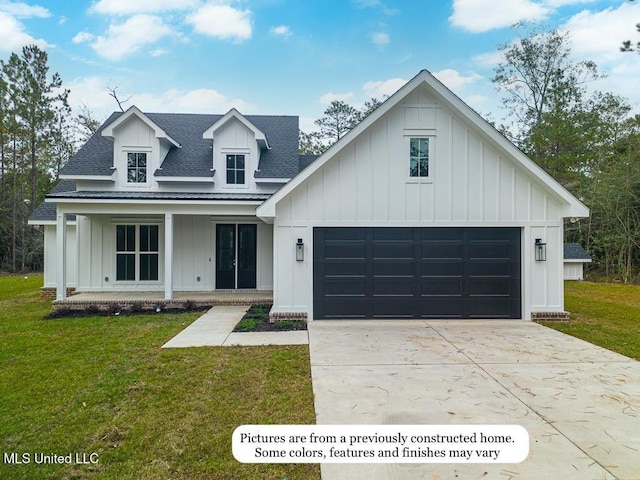 view of front of house featuring board and batten siding, a front yard, concrete driveway, and roof with shingles
