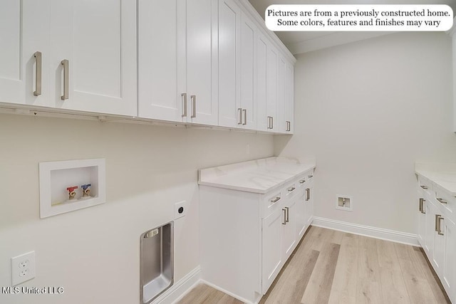 laundry area featuring cabinet space, washer hookup, baseboards, and light wood-style floors