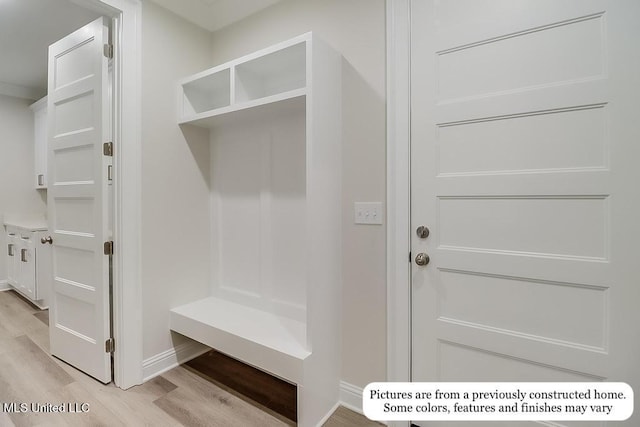 mudroom with baseboards and light wood-style flooring