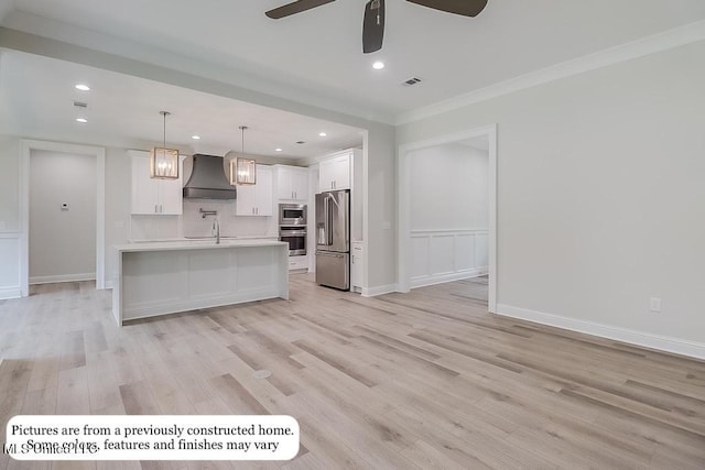 unfurnished living room with a sink, a ceiling fan, recessed lighting, and light wood-style flooring