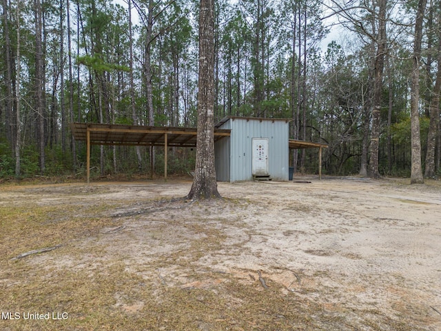 view of outbuilding featuring a carport and an outdoor structure