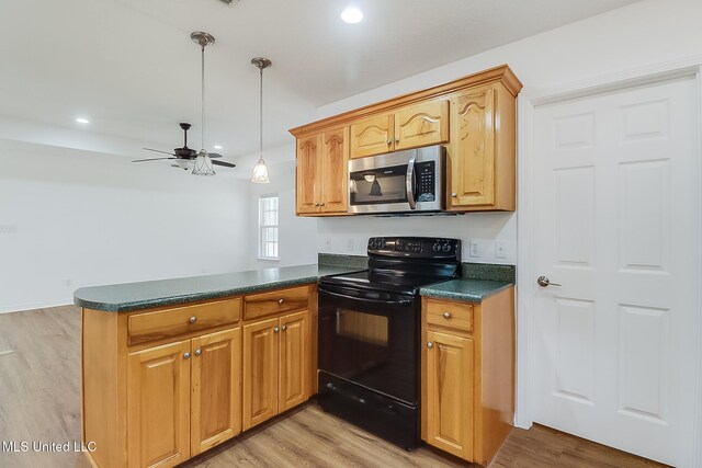 kitchen with black electric range, dark countertops, stainless steel microwave, light wood-style floors, and a peninsula