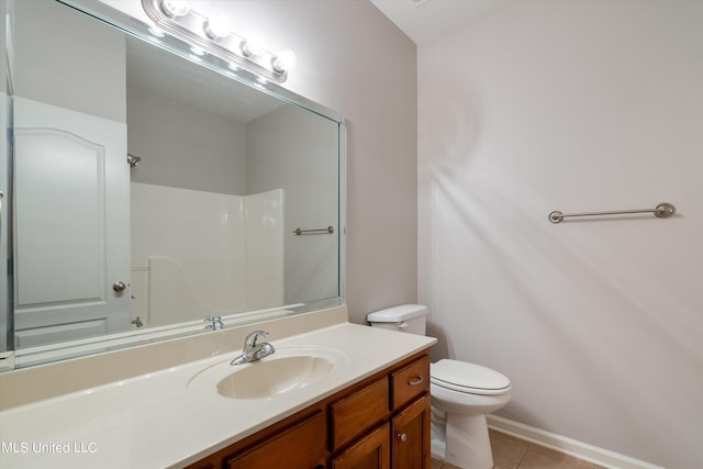 bathroom with vanity, toilet, tile patterned floors, and walk in shower