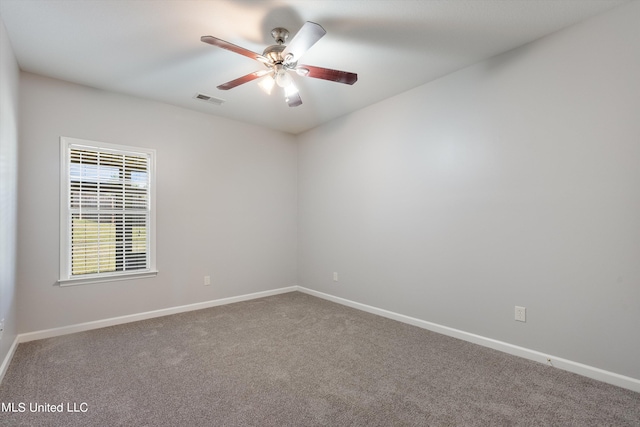 carpeted spare room with ceiling fan