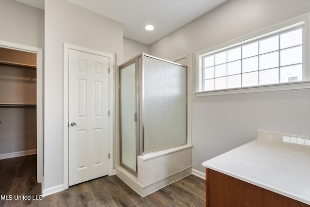 bathroom with walk in shower and wood-type flooring