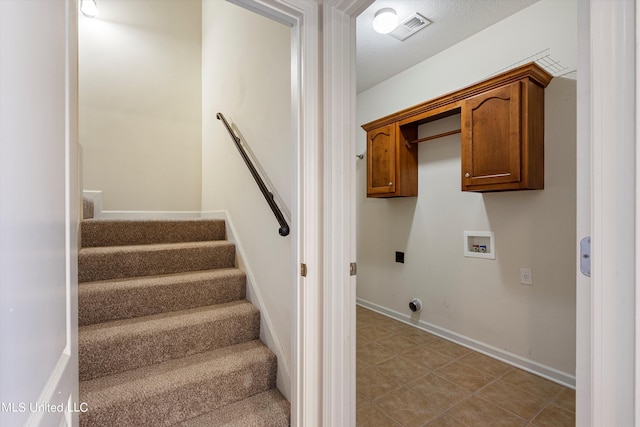 washroom with cabinets, hookup for a washing machine, and electric dryer hookup