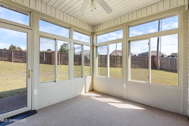 unfurnished sunroom featuring wooden ceiling and ceiling fan