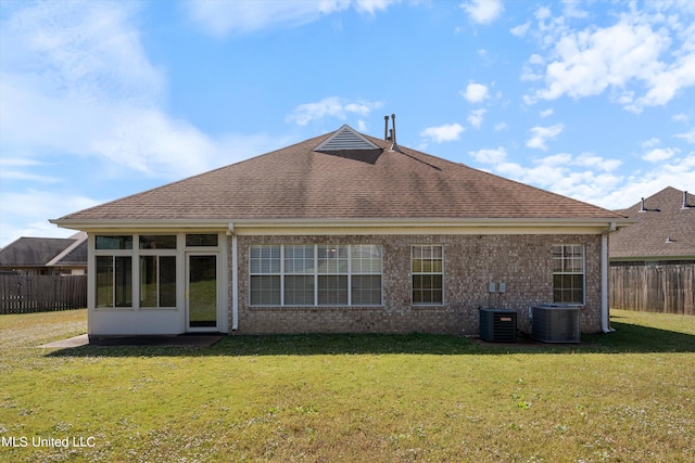 back of house featuring a yard and central AC unit