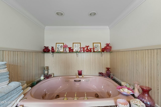 bathroom featuring crown molding and a bath