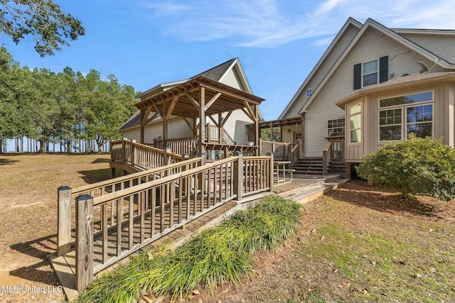 exterior space with a wooden deck, a gazebo, and a yard