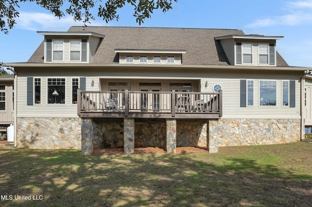 rear view of property featuring a wooden deck and a yard