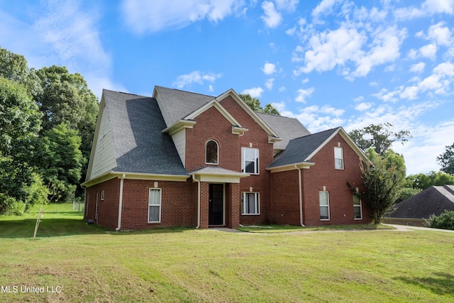 6308 Skyler Rd, Walls, MS 38680 - traditional home with a front yard, brick siding, and roof with shingles