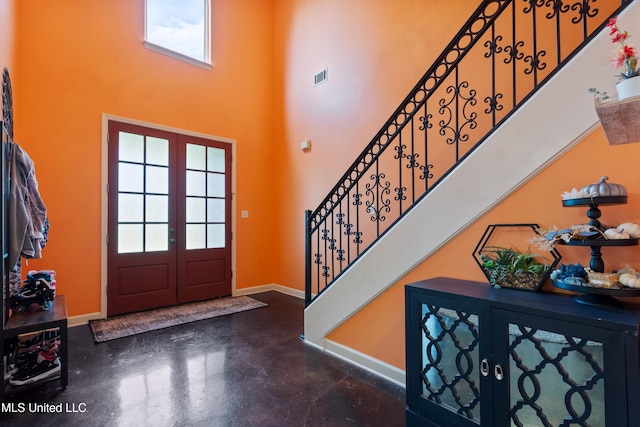 6308 Skyler Rd, Walls, MS 38680 - foyer featuring finished concrete flooring, stairs, plenty of natural light, and a high ceiling