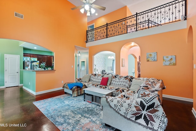6308 Skyler Rd, Walls, MS 38680 - living room featuring arched walkways, ceiling fan, a towering ceiling, and concrete flooring
