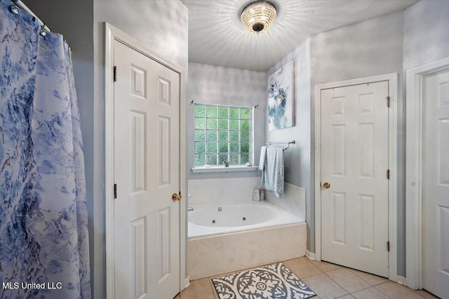 505 Golden Eagle Dr, Byram, MS 39272 - bathroom with a tub with jets and tile patterned flooring