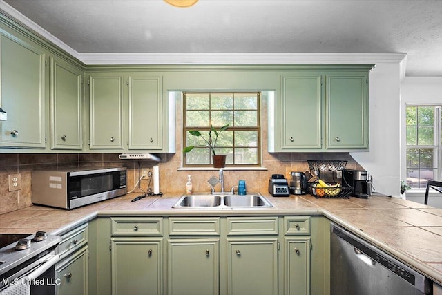 505 Golden Eagle Dr, Byram, MS 39272 - kitchen featuring stainless steel appliances, green cabinetry, crown molding, and backsplash