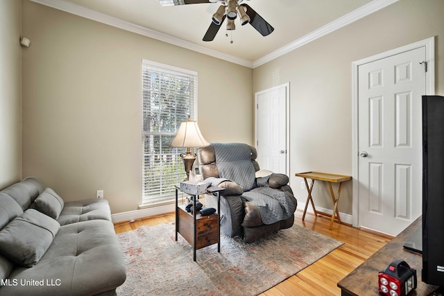 living area featuring hardwood / wood-style flooring, ceiling fan, and ornamental molding