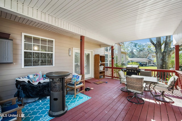 deck with covered porch and a grill