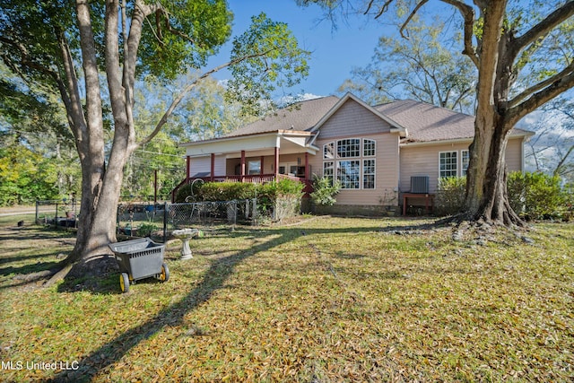 back of house featuring a yard and cooling unit