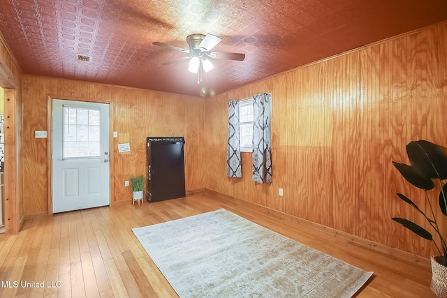 entrance foyer featuring hardwood / wood-style flooring, an ornate ceiling, visible vents, and a wealth of natural light