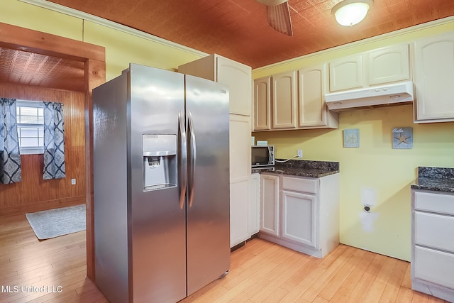 kitchen with light wood-style flooring, white cabinetry, black microwave, under cabinet range hood, and stainless steel fridge with ice dispenser