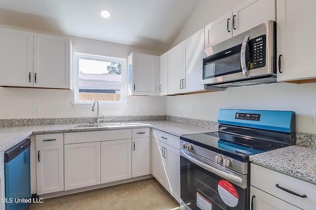 kitchen featuring white cabinetry, sink, vaulted ceiling, and appliances with stainless steel finishes