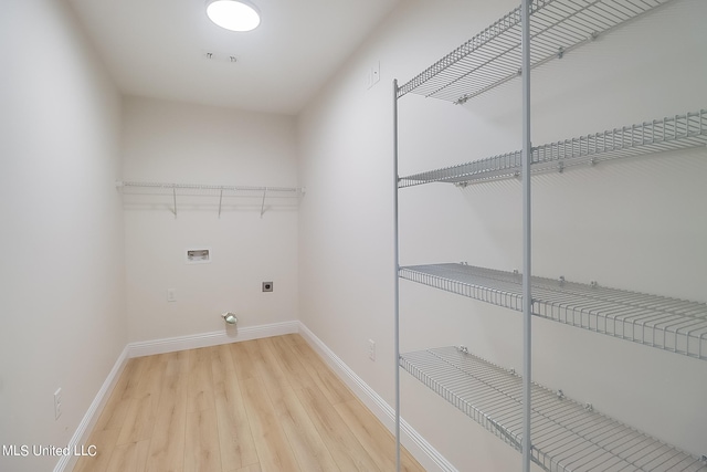 clothes washing area with hardwood / wood-style floors, hookup for a washing machine, and electric dryer hookup