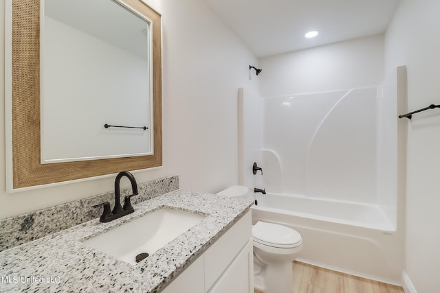 full bathroom with vanity, toilet, shower / bathing tub combination, and hardwood / wood-style flooring