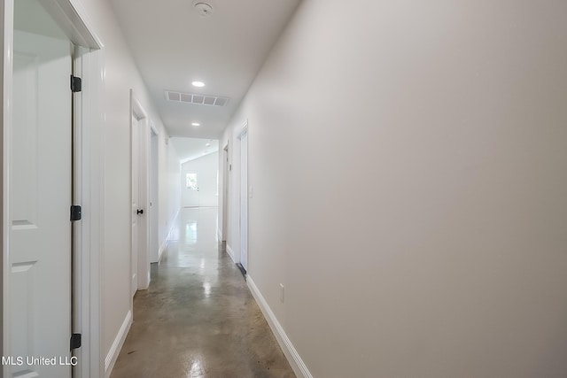 hallway with concrete floors