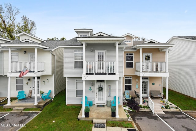 multi unit property featuring a balcony, french doors, and a patio area